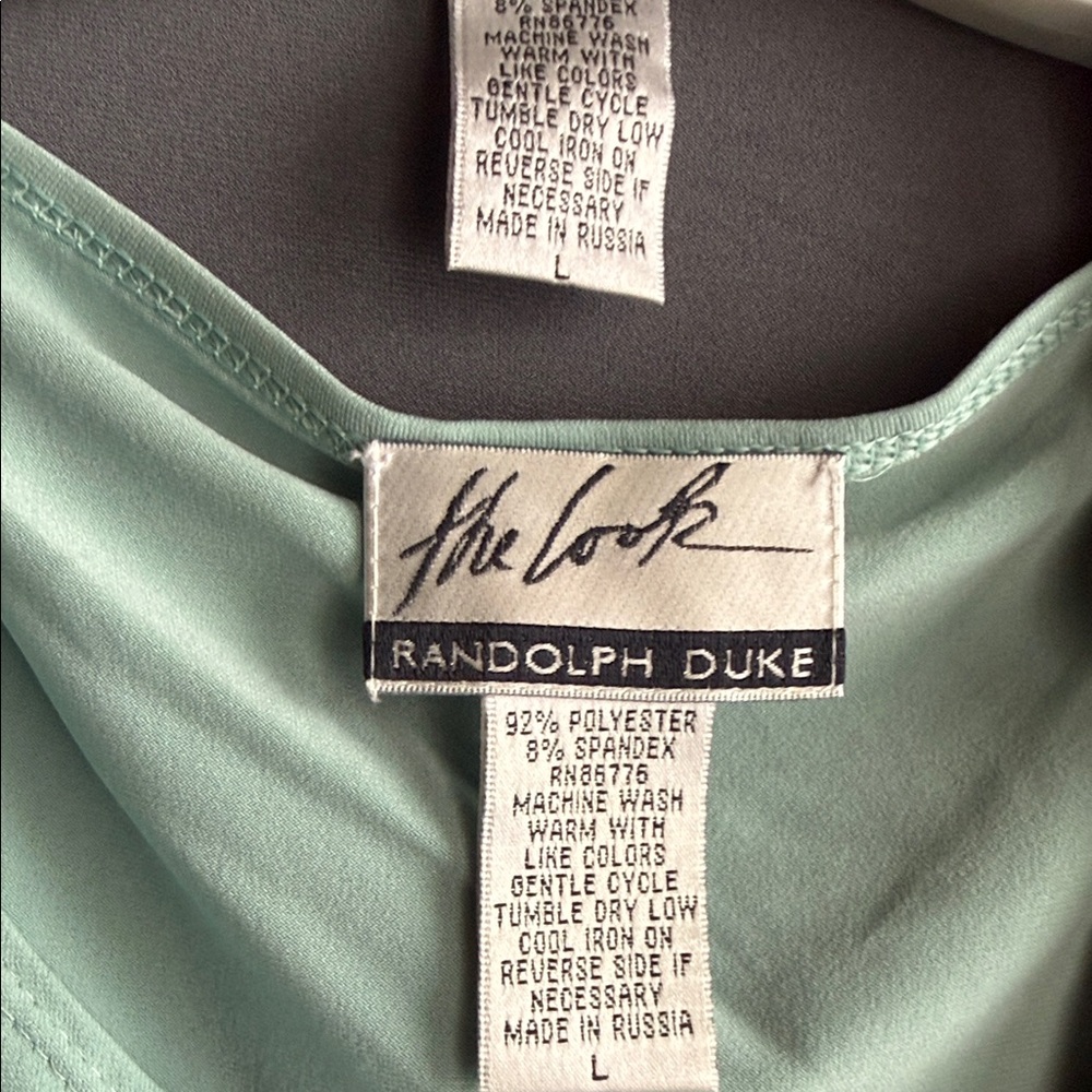 Randolph Duke Light Green Blouse & long sleeve gray jacket.